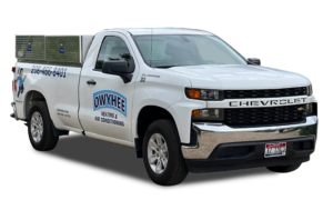 White Chevrolet pickup truck with Owyhee Heating & Air Conditioning branding and phone number on the side door.