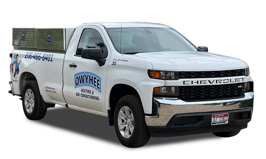 White Chevrolet pickup truck with Owyhee Heating & Air Conditioning branding and phone number on the side door.